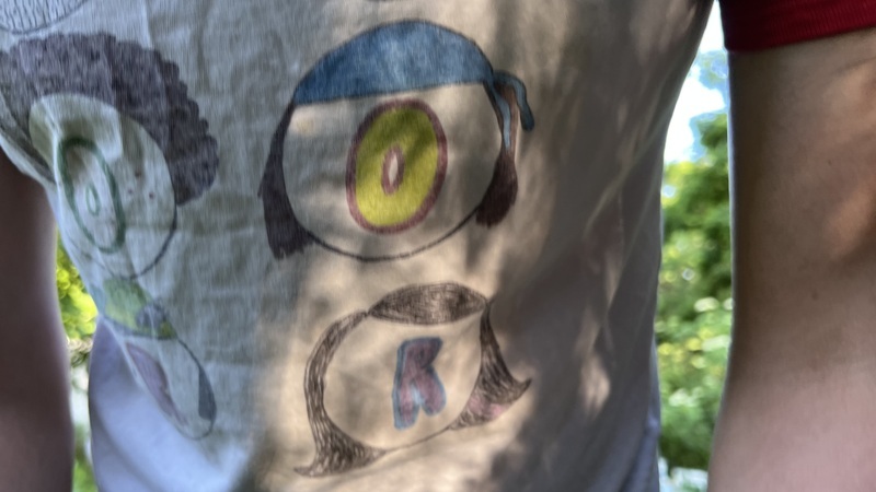 a person in a torpor tshirt with sunlight at Awbury Arboretum in Philadelphia PA