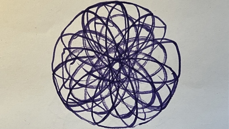 a spirograph drawing in purple marker on white paper